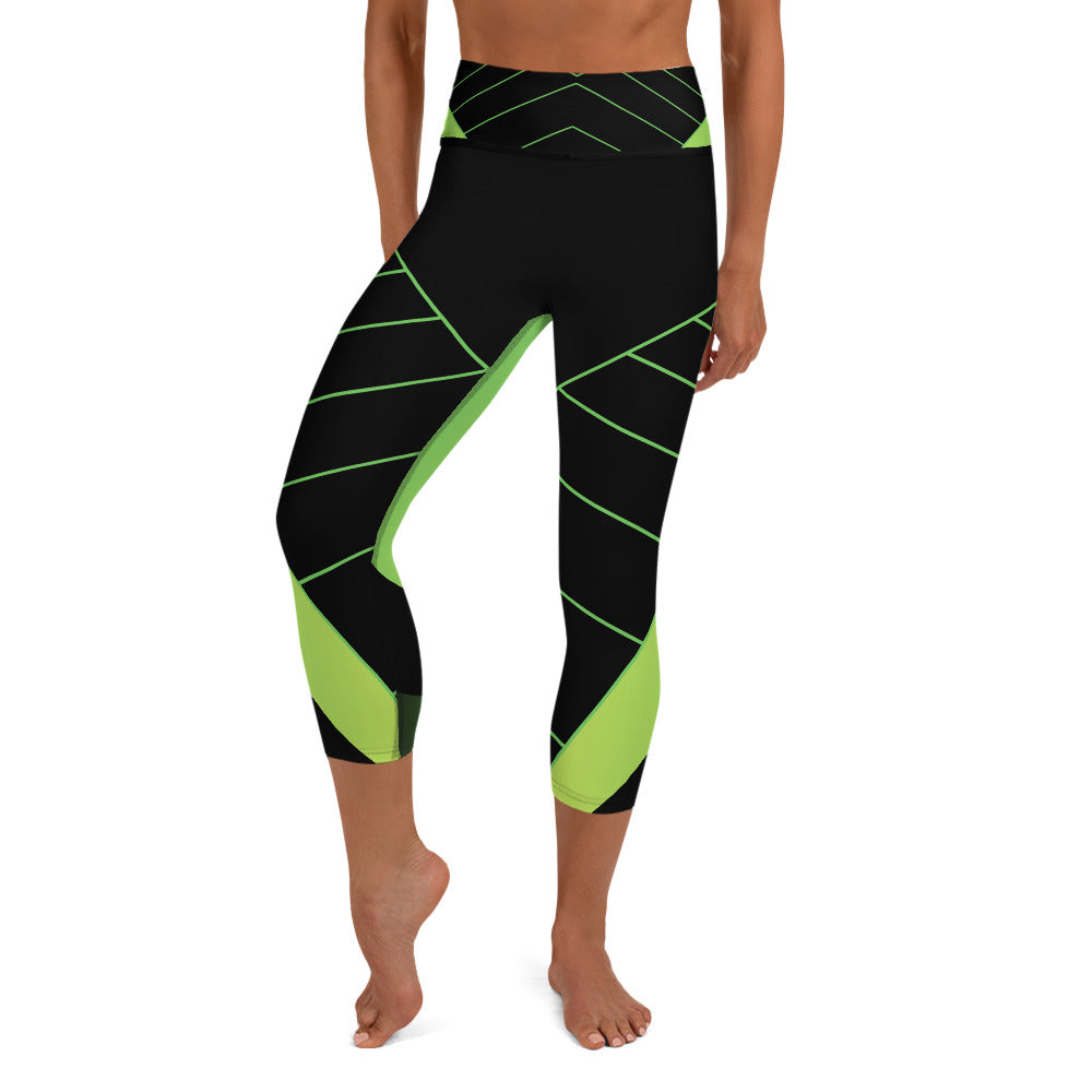 front view of a barefoot woman wearing black and neon yellow capri length yoga pants